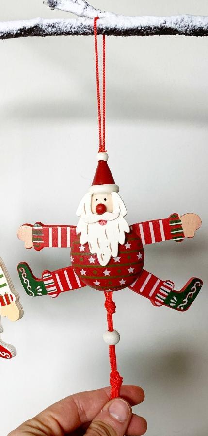 Wooden hanging Father Christmas, round tummy arms and legs stretched out red silky string bottom and top.