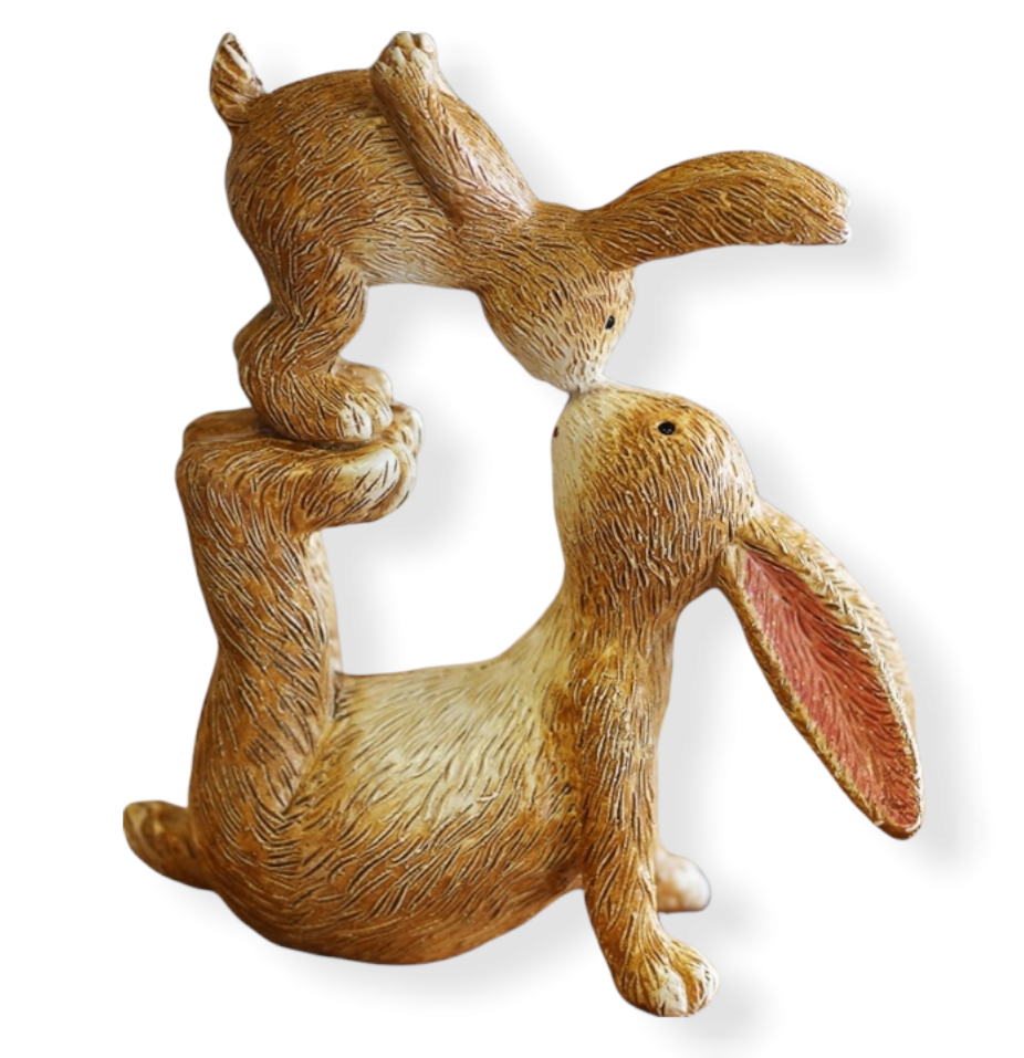 light brown & white, intricate fur detail,  resting with front arms leaning back, back legs up in the air with  baby rabbit standing on his feet leaning over to kiss the adult rabbit