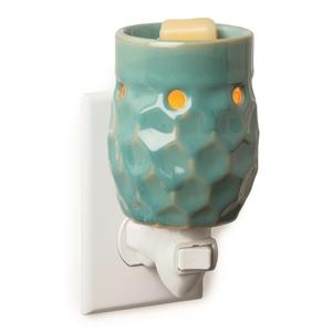 Teal coloured, honeycomb Shaped, small circles cut out at top, ceramic electric plugin wax melter.