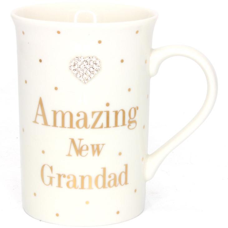 Tall slim cream mug with some gold dots,  gold  wording ' Amazing New Grandad' and a diamanté heart embellishment.