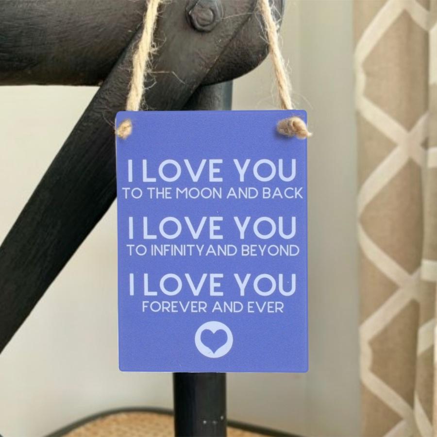 Small blue hanging sign, whit text ' I love you to the moon and back, I love you to infinity and beyond, I love you forever and ever',