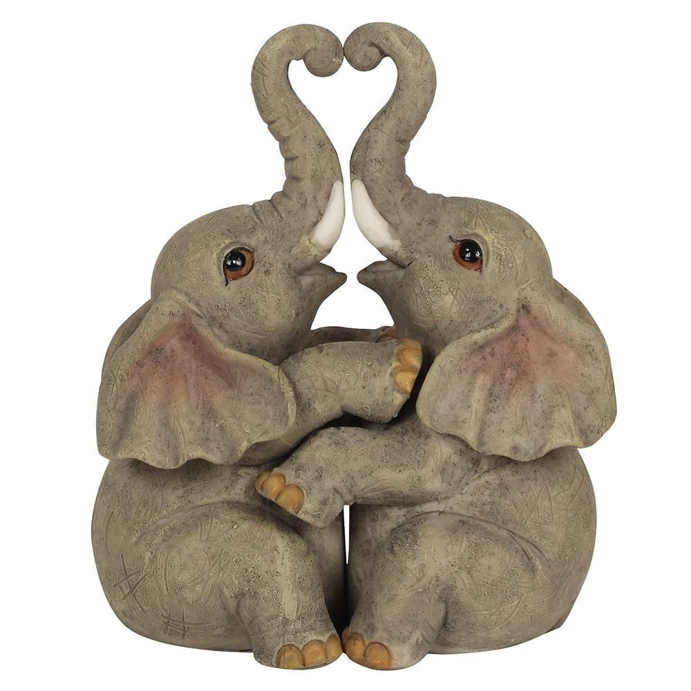 Two sitting elephants, hugging, trunks up making a heart shape