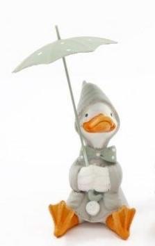 Sitting duck wearing a sage green rain coat and holding an open umbrella