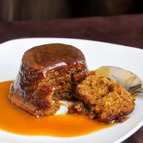 Sticky toffee pudding on a plate.