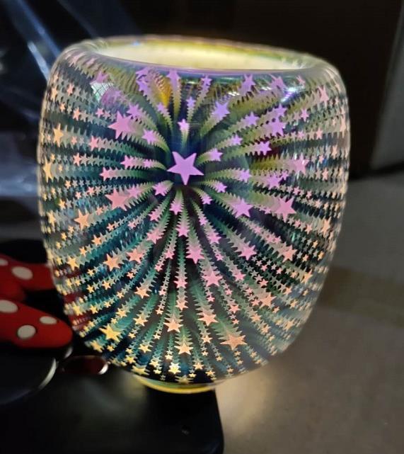Circular Glass, electric wall plugin glowing with yellow / pink /purple 3d small shooting stars.