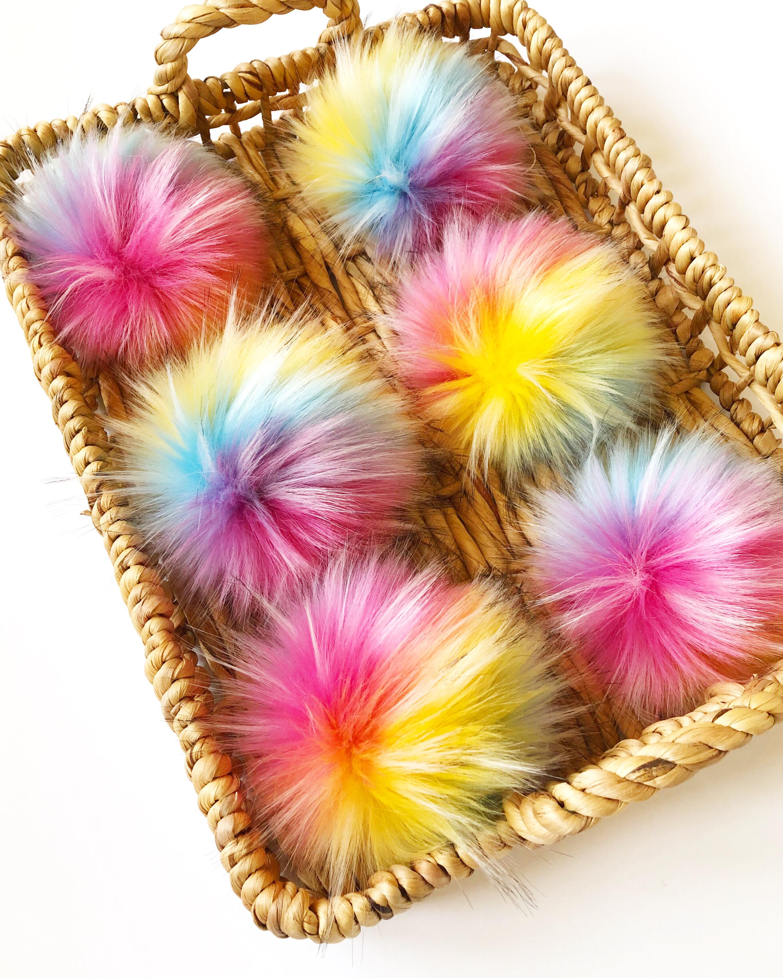 soft faux fur pom poms in various colours, perfect for decorating crochet and knit beanies