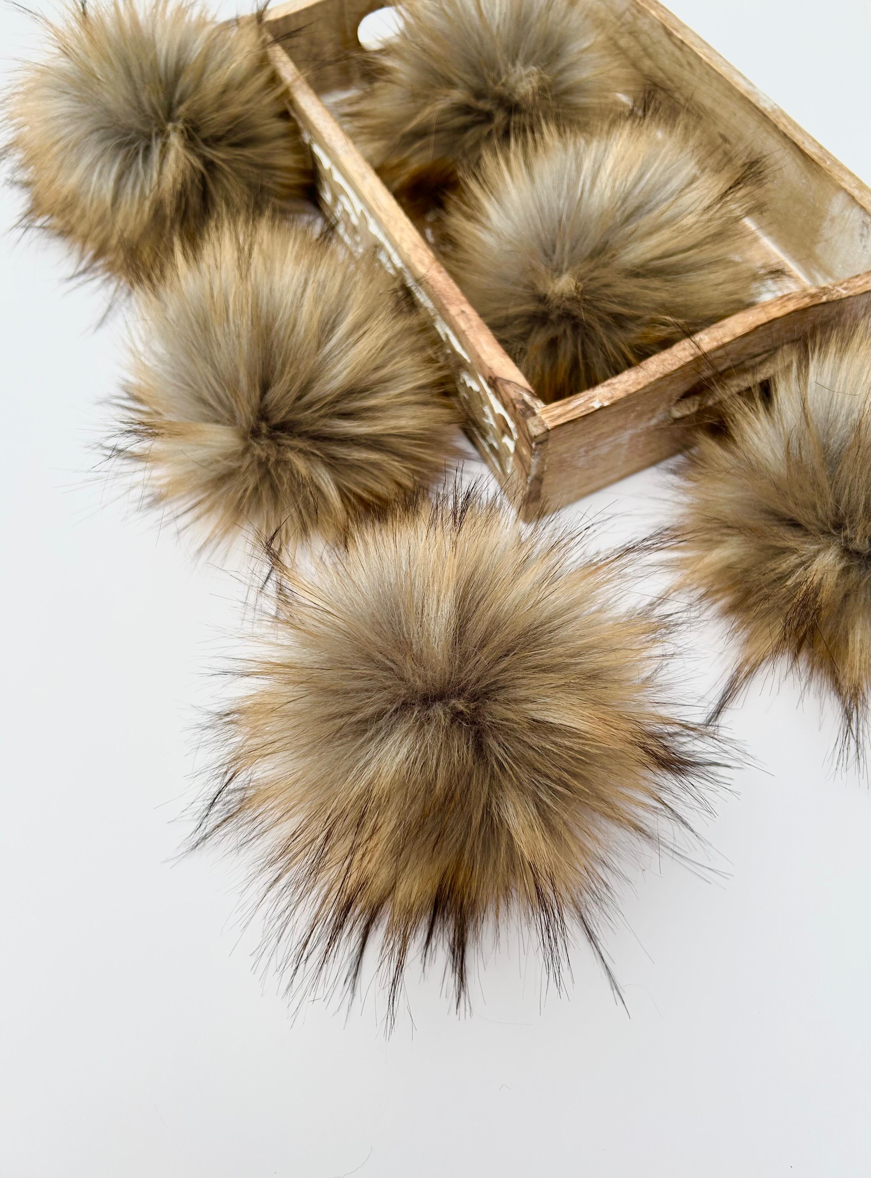 soft faux fur pom poms in a brown colour, perfect for decorating crochet and knit beanies