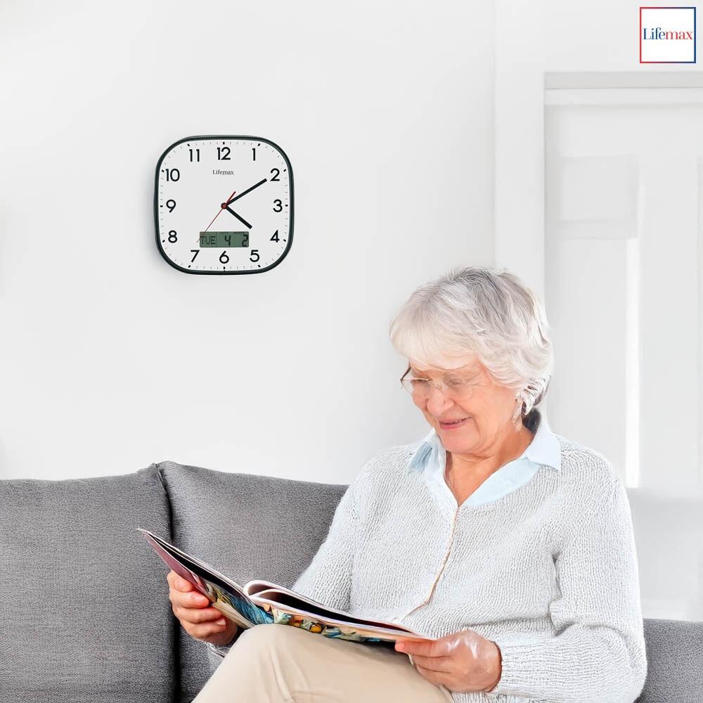 Lifemax White faced clear time day date clock hung in a living space