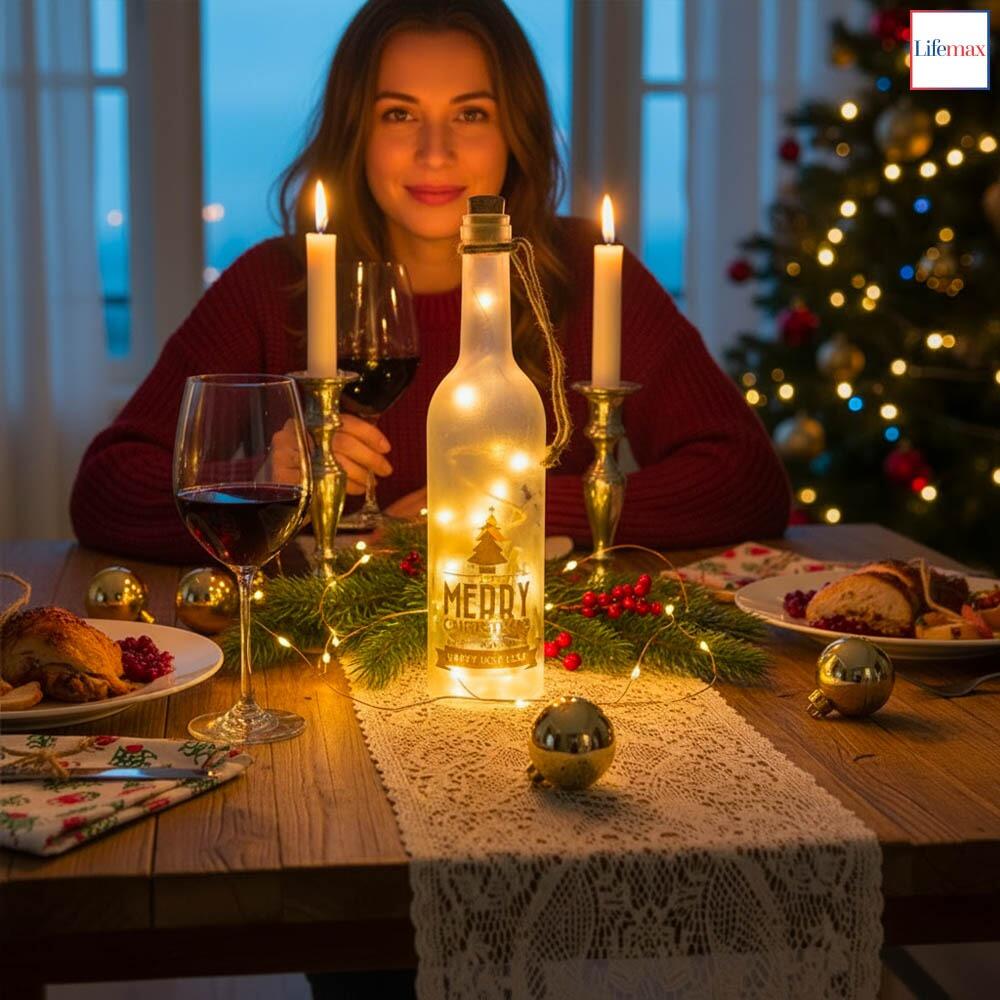 Lifemax Sparkling LED Christmas Wine Bottle Decoration on a prepared christmas table with a lady enjoying wine in the background