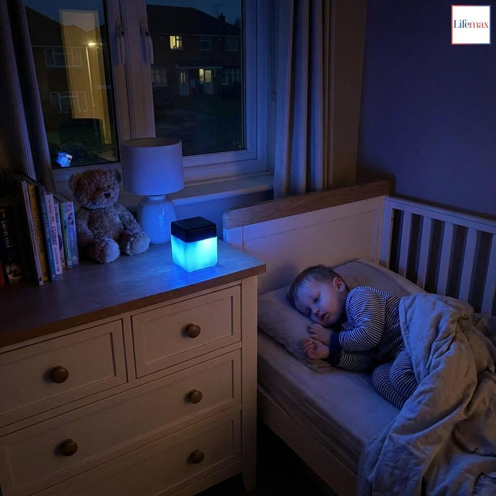 A young toddler listening to nature sounds on a a Lifemax mood light bluetooth speaker illuminated blue to help him go to sleep