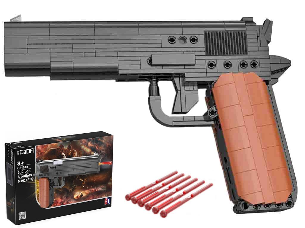 Interlocking block toy M1911 pistol pretend weapon left view black tan colours with retail box packaging white background