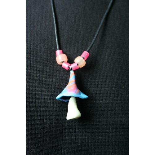 Picture of handmade UV mushroom necklace glowing under Neon lights
