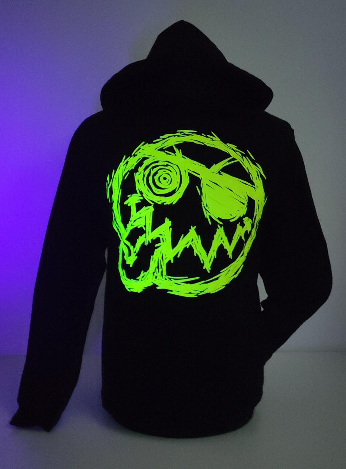 Picture of a stinky fish hoodies taken under uv light. Black hoodie with UV yellow smiley design
