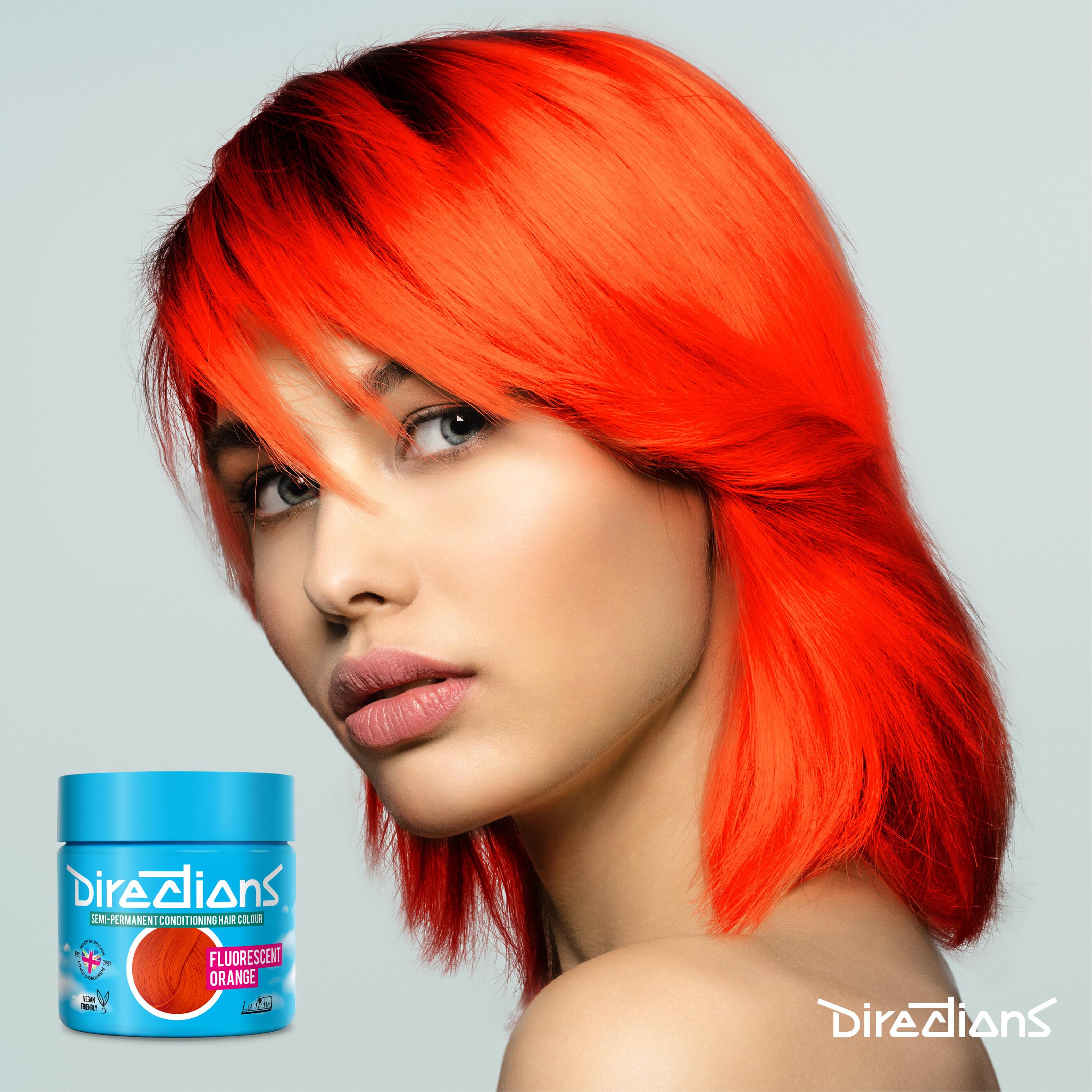 Fluorescent orange directions hair dye colour on a model with long hair