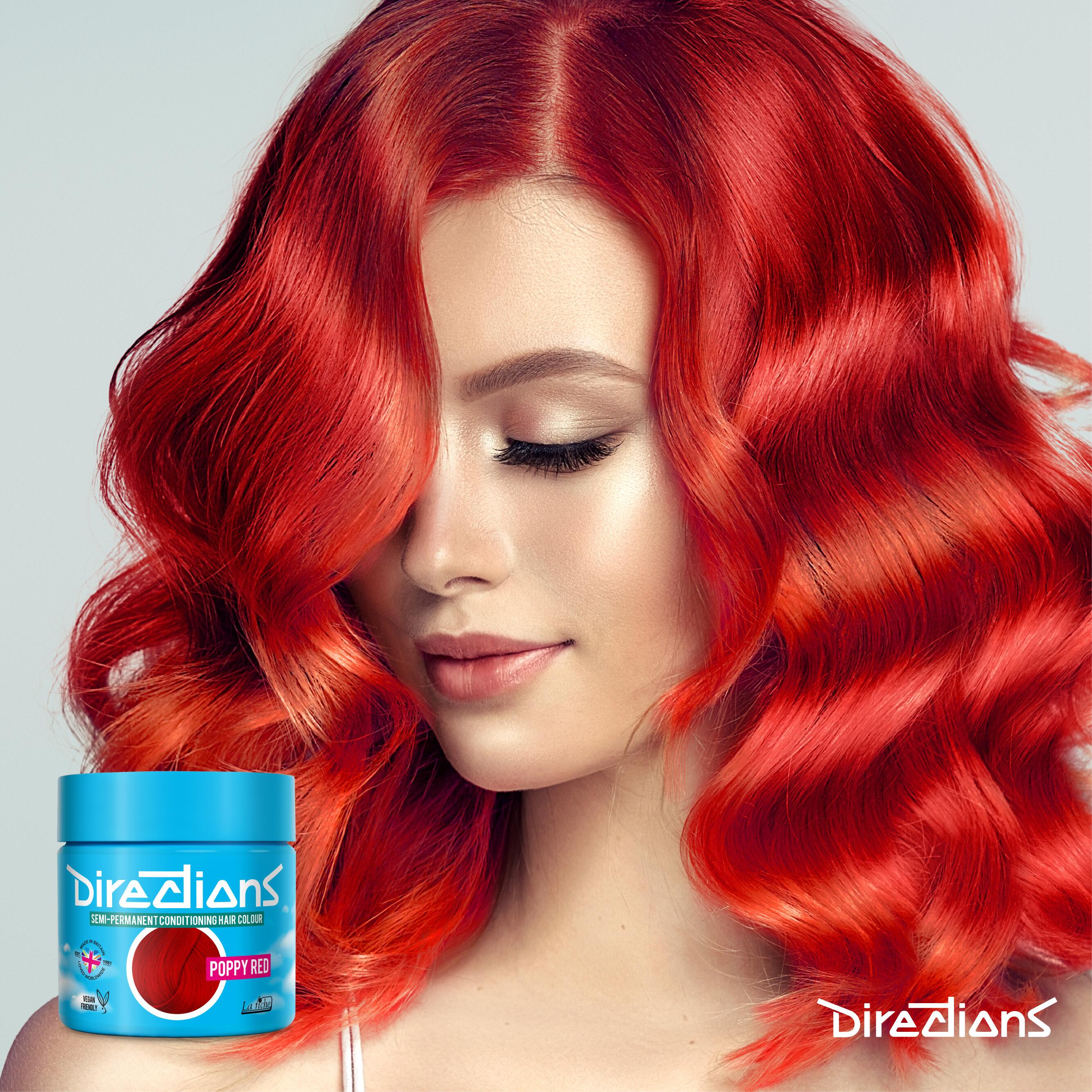 Poppy red directions hair dye colour on a model with long wavey hair