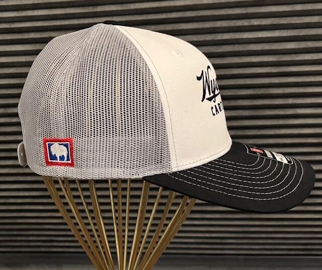 side view of gray mesh of hat with off centered small state of Wyoming bison logo