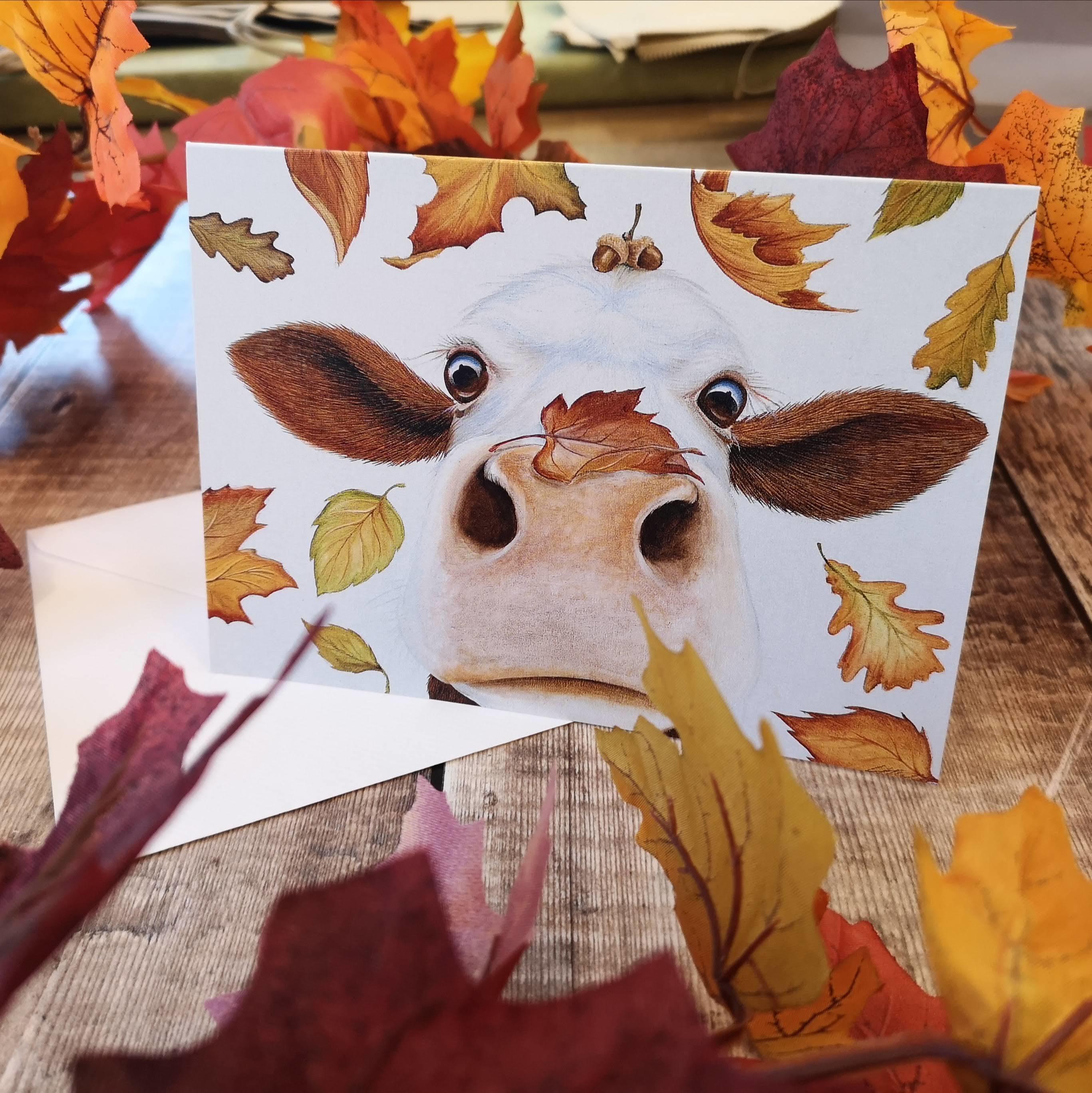 greetings card with an autumn inspired cow