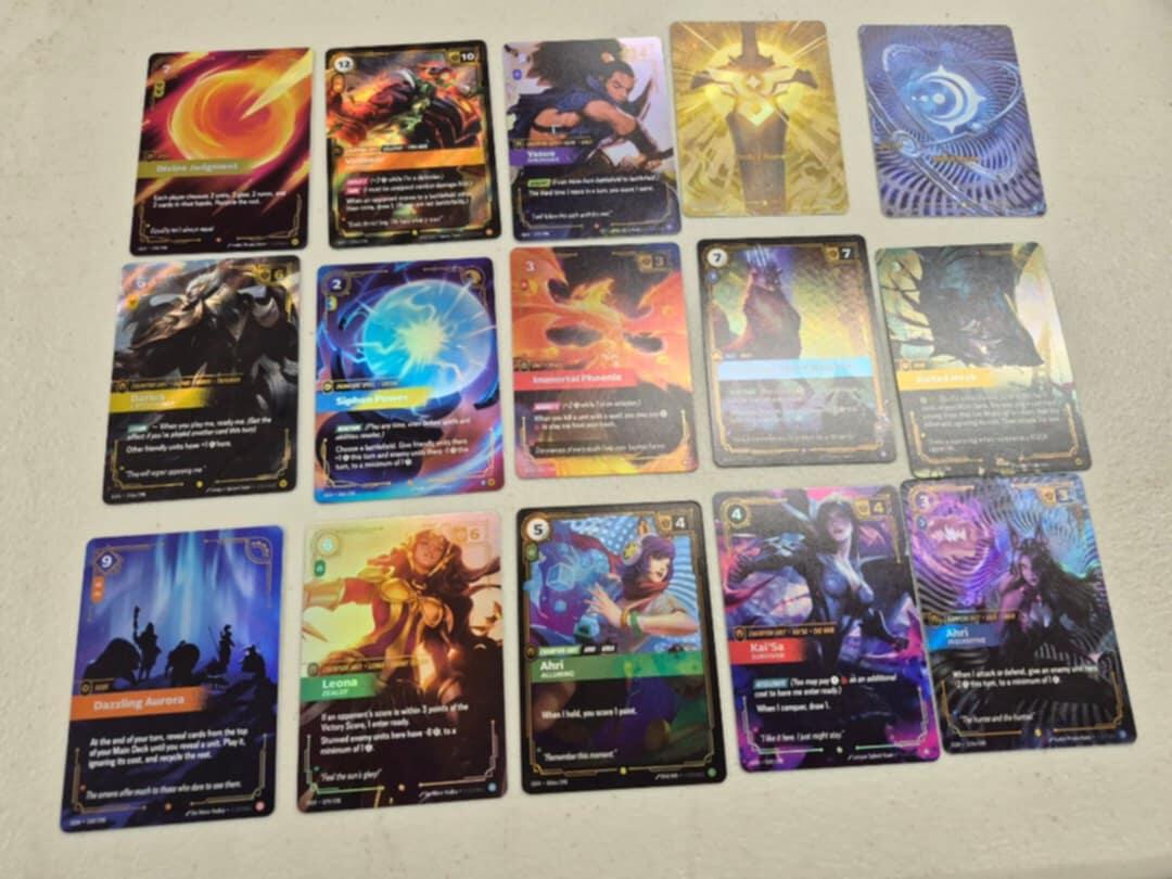 Rare foil cards from Riftbound League of Legends TCG featuring Ahri, Yasuo, and Kai'Sa.