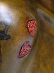 Red garnet in the heart-shaped tattoos 