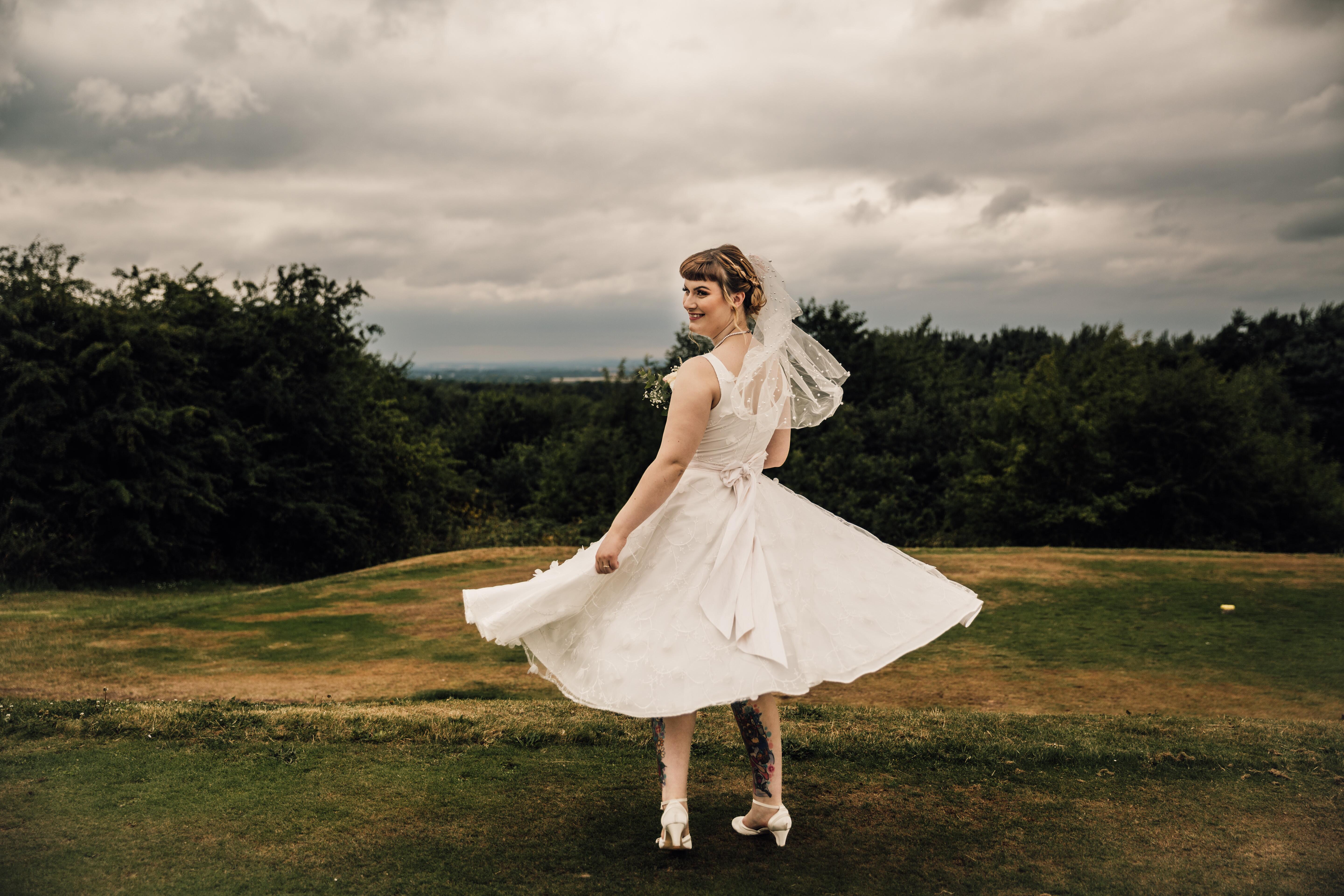alternative real bride wearing full skirted 1950s style wedding dress made by Dig For Victory