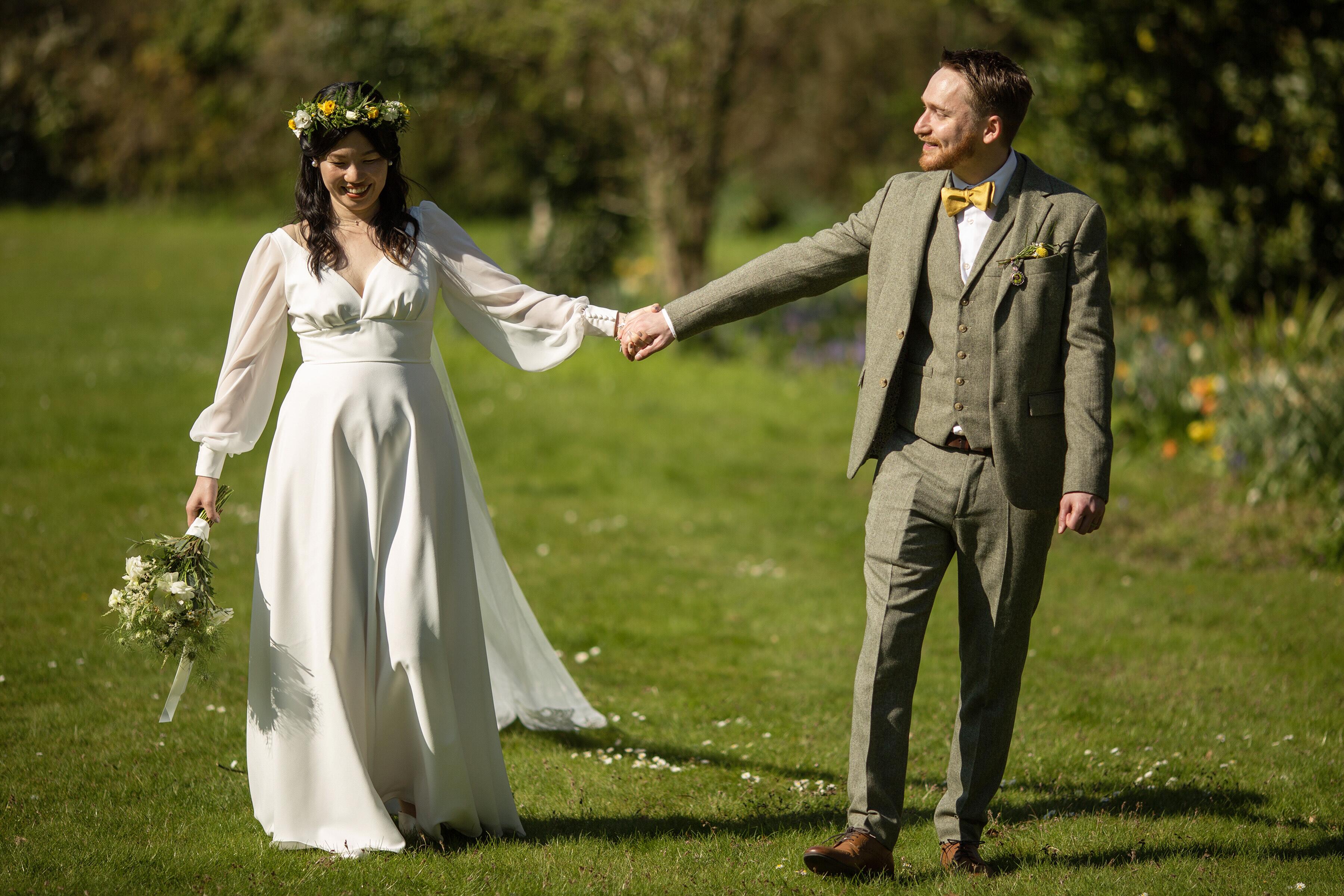 beautiful real bride wearing a full length Dig For Victory boho wedding dress with full length bishop sleeves