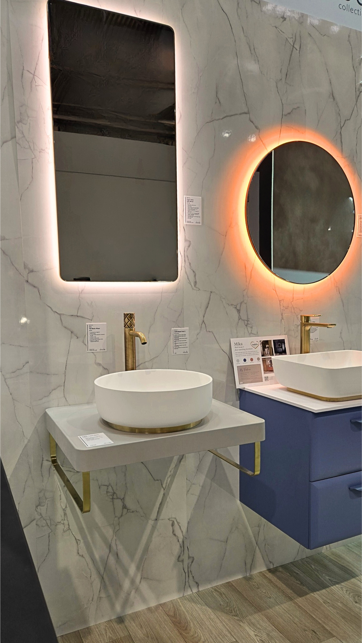 Layered bathroom lighting with mirror light and wall sconces in warm tones