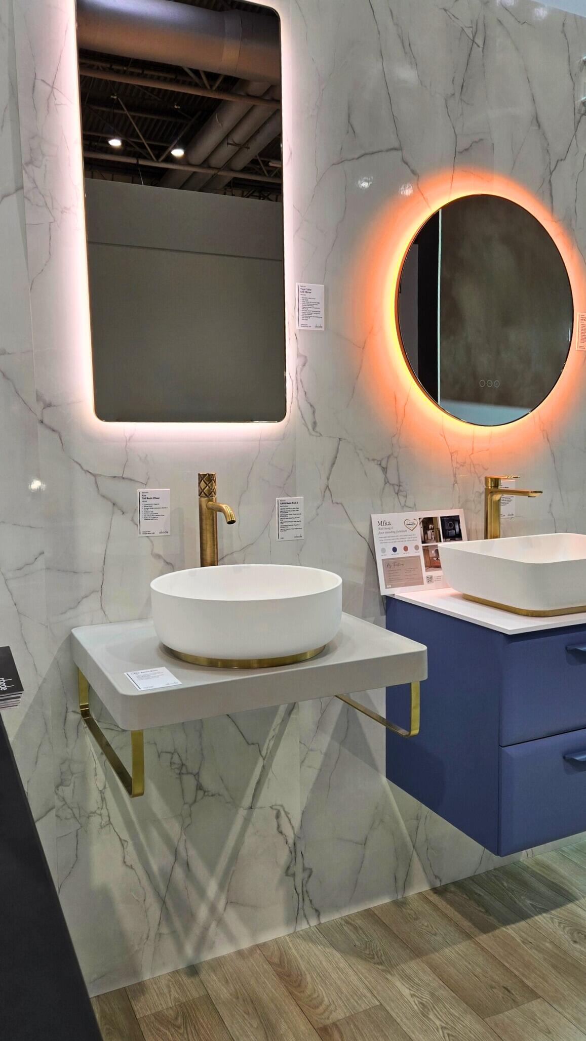 Large-format tiles and brushed brass taps in a spa-inspired bathroom