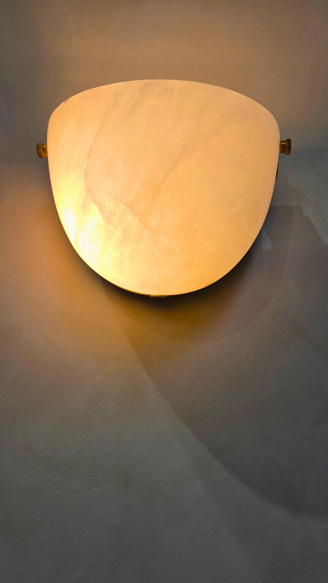 Warm-toned bathroom lighting layers with wall lights and soft glow