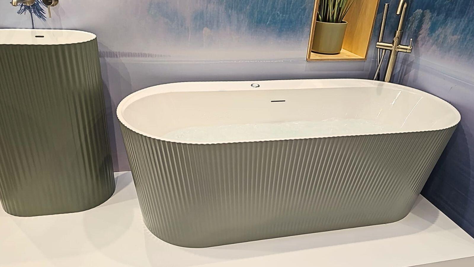 Sage green fluted freestanding bath with whirlpool jets and brass fittings