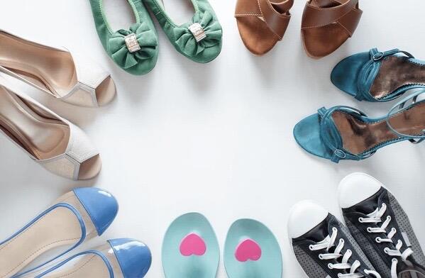 Selection of ladies footwear arranged in a circle on a white background