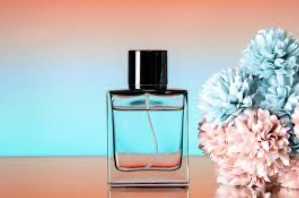 Single fragrance bottle on vibrant pink and blue background