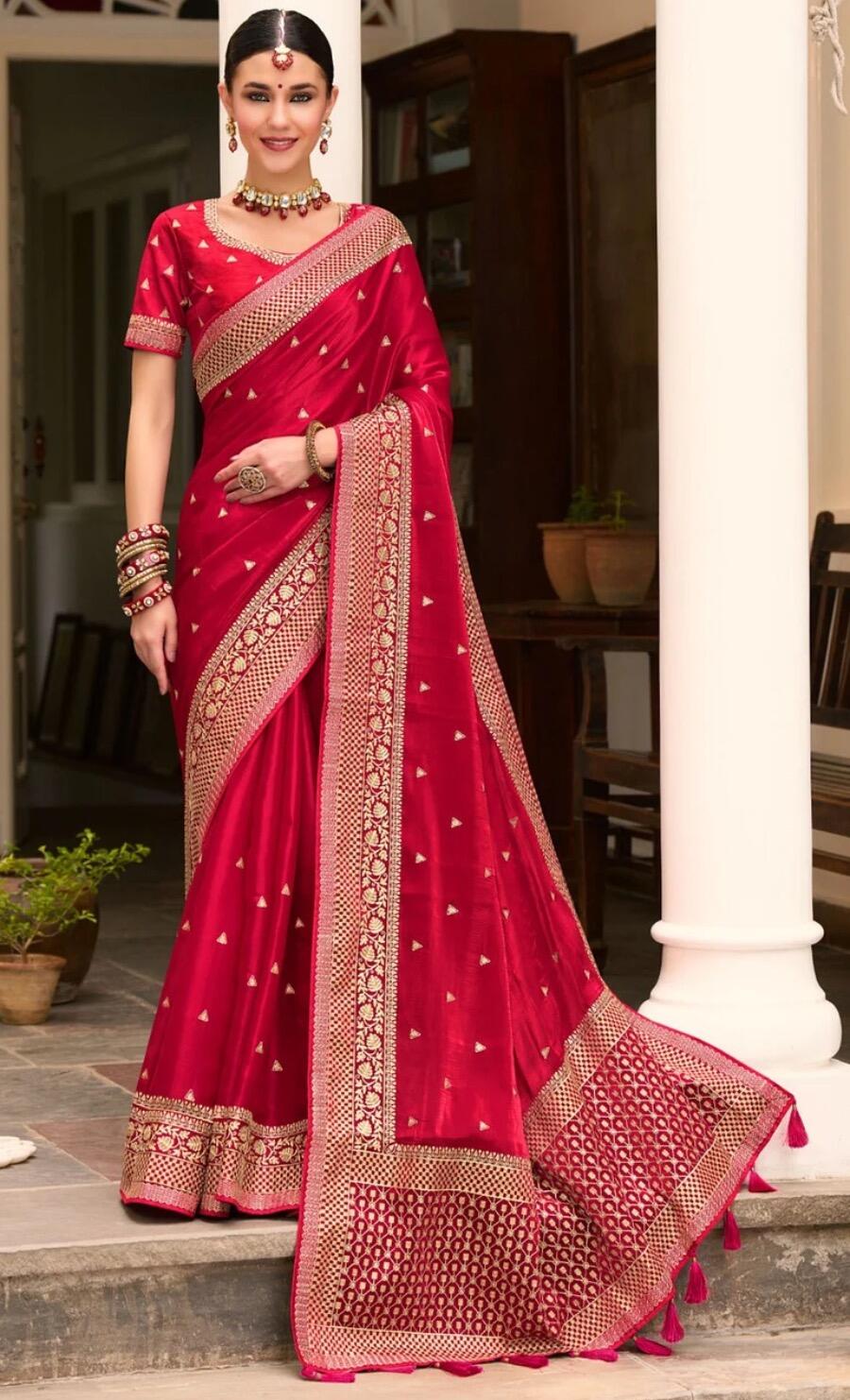 Female standing wearing pink Saree