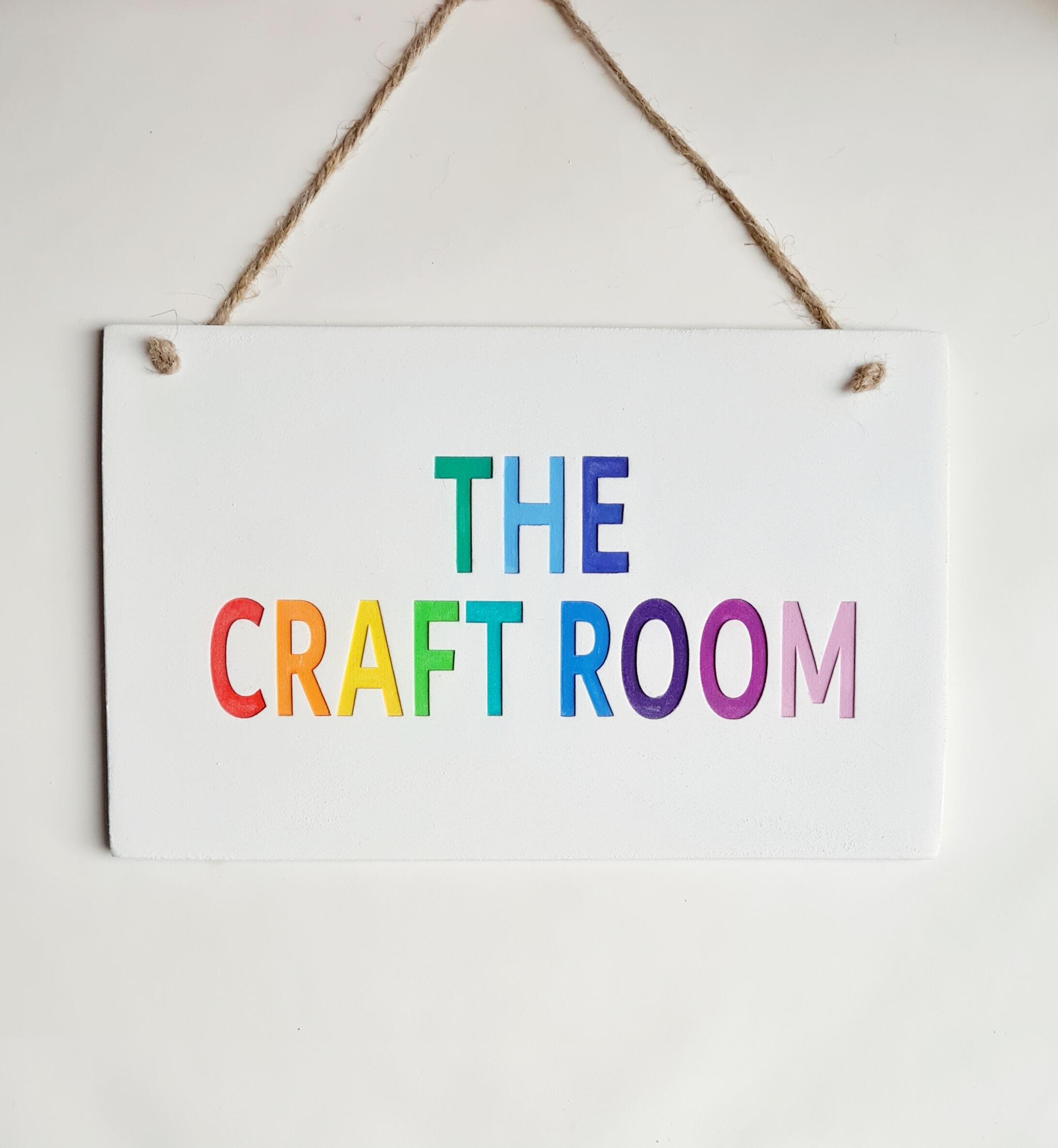 The craft room rainbow door sign