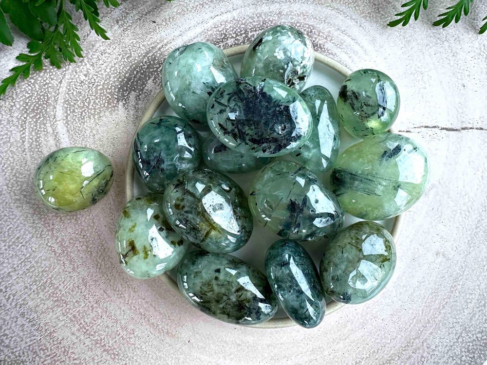 large prehnite green tumble stones with black tourmaline inclusions