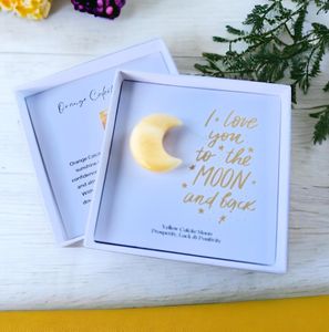 yellow calcite crystal moon in a gift box with the quote I love you to the moon and back within