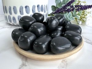shungite black tumble stones on a plate, the holistic hamper crystals online shop UK