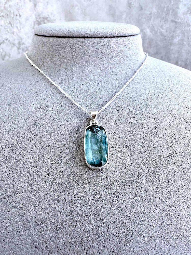 green kyanite rectangular crystal pendant on sterling silver on display bust with optional chain