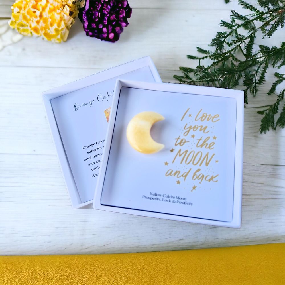 Orange calcite crystal moon in a gift box with the quote I love you to the moon and back within