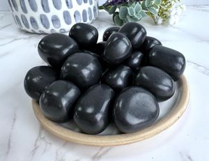 shungite black tumble stones on a plate, the holistic hamper crystals online shop UK
