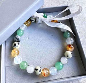 manifesting good luck crystal bracelet with Dalmatian jasper, moonstone, rutiliated quartz, citrine and aventurine in box