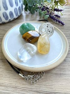Manifestation crystal cage necklace set with four tumble stones from the holistic hamper crystal shop