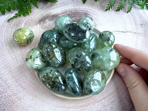 large prehnite green tumble stones with black tourmaline inclusions