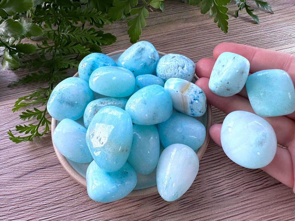 Blue aragonite tumbled stones on a dish natural crystals