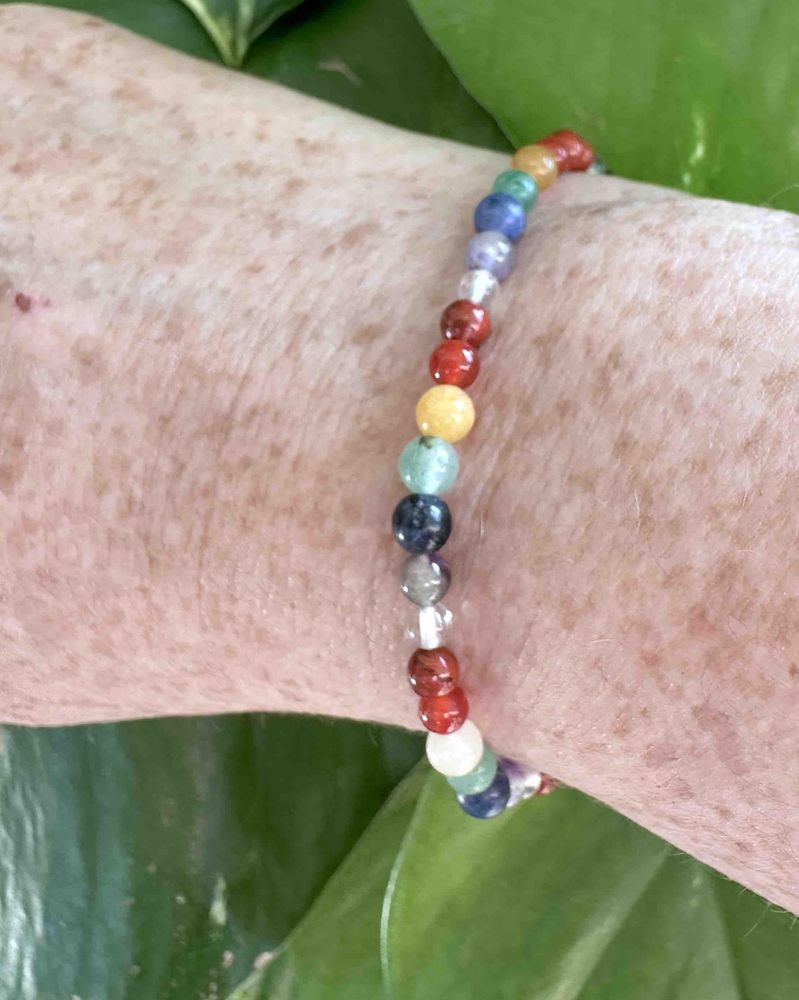 4mm round bead chakra crystal stretch bracelets in rainbow colours on wrist