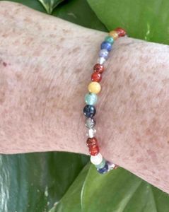 4mm round bead chakra crystal stretch bracelets in rainbow colours on wrist