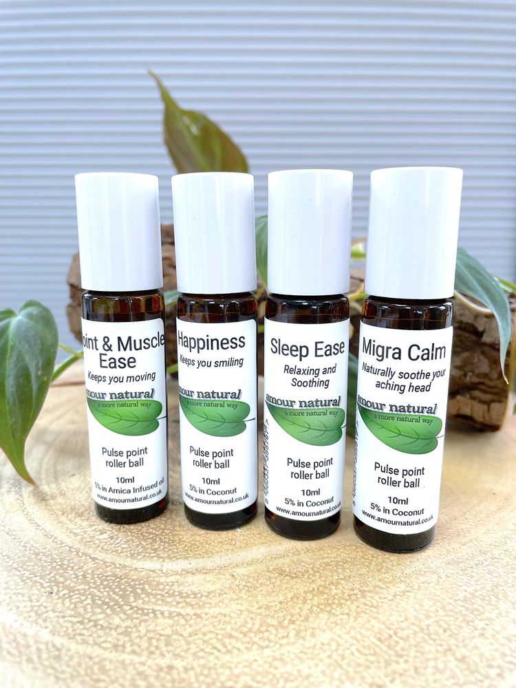 lined up set of essential oil rollerballs including migraine calm
