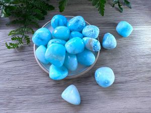 Blue aragonite tumbled stones on a dish natural crystals