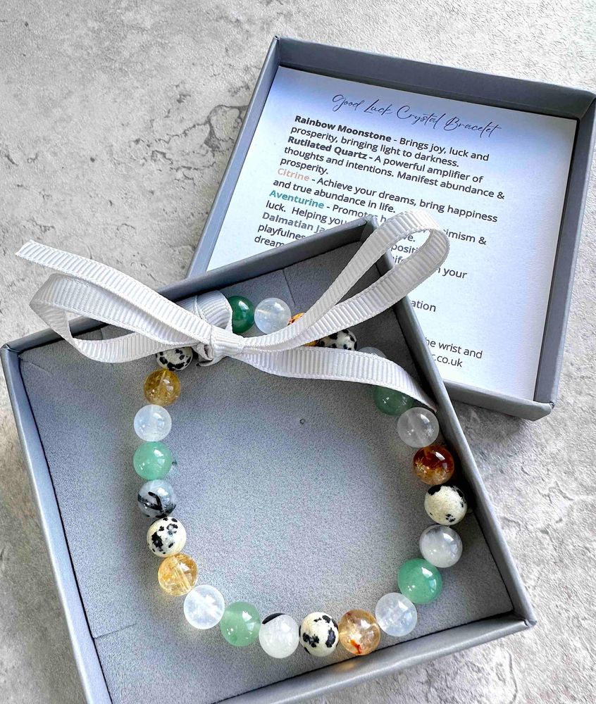 manifesting good luck crystal bracelet with Dalmatian jasper, moonstone, rutiliated quartz, citrine and aventurine in box