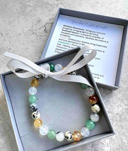 manifesting good luck crystal bracelet with Dalmatian jasper, moonstone, rutiliated quartz, citrine and aventurine in box