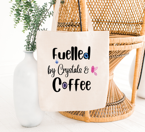fuelled by crystals tote bag hanging on a chair
